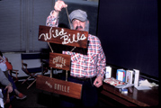 Bill holding Wild Bill's Coffeeshop sign